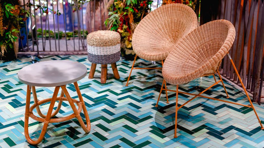 Elegant rattan furniture set on colorful chevron tile flooring in a Thai resort setting.